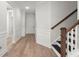 Bright entryway features elegant hardwood floors, wainscoting, and a classic staircase at 123 Leeward Lndg, Summerville, SC 29486