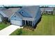 Attractive home with a well-kept lawn, attached garage, and inviting covered porch with seating at 123 Leeward Lndg, Summerville, SC 29486