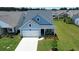 Bright exterior view featuring a manicured front yard and charming front porch seating area at 123 Leeward Lndg, Summerville, SC 29486