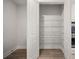 Walk-in pantry features white wire shelving, white doors, and wood-look flooring at 123 Leeward Lndg, Summerville, SC 29486