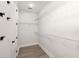 Walk-in closet features white wire shelving, ample storage space, and wood-look flooring at 123 Leeward Lndg, Summerville, SC 29486