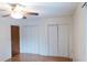Bright bedroom featuring hardwood floors, ceiling fan, and closet space at 124 Brush Blvd, Goose Creek, SC 29445