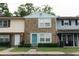 A well-maintained townhome showcases a brick exterior, complemented by tidy landscaping and individual character at 124 Brush Blvd, Goose Creek, SC 29445