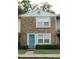 A cozy townhome showcases a charming brick exterior and a vibrant turquoise front door at 124 Brush Blvd, Goose Creek, SC 29445