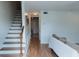 Open-concept living area features wood floors, crisp white walls, and easy access to the staircase at 124 Brush Blvd, Goose Creek, SC 29445