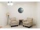 A cozy sitting area is illuminated by modern light fixtures and furnished with comfortable armchairs at 124 Brush Blvd, Goose Creek, SC 29445