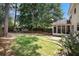 Large backyard with mature trees, a swing set, screened in porch, and partial privacy fence at 133 Guildford Dr, Goose Creek, SC 29445