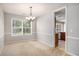 Cozy dining room with a chandelier and a window overlooking the backyard at 133 Guildford Dr, Goose Creek, SC 29445