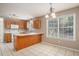 Open kitchen with a breakfast bar and an adjacent dining area with backyard views at 133 Guildford Dr, Goose Creek, SC 29445