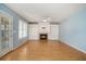 Cozy living room with built-in shelves, fireplace, wood floors, and an abundance of natural light at 133 Guildford Dr, Goose Creek, SC 29445