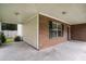 Spacious covered porch featuring brick accents and a concrete floor at 133 Guildford Dr, Goose Creek, SC 29445