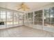 Well-lit sun room with large windows, tile floors, and a ceiling fan at 133 Guildford Dr, Goose Creek, SC 29445