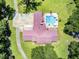 This aerial view shows a home with a backyard pool and a spacious driveway and basketball court at 138 Brant Acres Ln, Bonneau, SC 29431