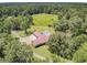 Aerial shot shows a home with a large pool area and green lawn, surrounded by mature trees and landscaping at 138 Brant Acres Ln, Bonneau, SC 29431