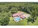 Aerial view featuring home with backyard pool, patio, and spacious green yard surrounded by mature trees at 138 Brant Acres Ln, Bonneau, SC 29431