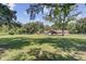 Large backyard with a spacious green lawn and a home with an outdoor seating area at 138 Brant Acres Ln, Bonneau, SC 29431