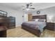 This primary bedroom features stylish wood flooring, a ceiling fan, and ample space, creating a relaxing retreat at 138 Brant Acres Ln, Bonneau, SC 29431