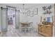 Inviting dining room features chandelier, wood table, and barn door pantry access at 138 Brant Acres Ln, Bonneau, SC 29431