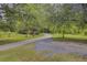Winding driveway through a lush, green landscape at 138 Brant Acres Ln, Bonneau, SC 29431