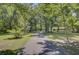 Long, paved driveway leading to a home, bordered by trees and lawn at 138 Brant Acres Ln, Bonneau, SC 29431