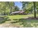 Scenic home with a long, inviting porch and large yard shaded by mature trees at 138 Brant Acres Ln, Bonneau, SC 29431