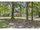 Home with metal roof, brick facade and an inviting, covered front porch, nestled among mature trees at 138 Brant Acres Ln, Bonneau, SC 29431