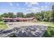 Property features a large entertainment area, garage, drive and concrete area, with mature shade trees at 138 Brant Acres Ln, Bonneau, SC 29431