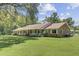 Charming brick home with a metal roof, spacious front yard and inviting, covered front porch at 138 Brant Acres Ln, Bonneau, SC 29431