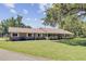Brick house with metal roof and long, covered front porch in a well-maintained lawn at 138 Brant Acres Ln, Bonneau, SC 29431