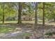 This lovely property showcases a metal roof and picturesque setting with mature trees at 138 Brant Acres Ln, Bonneau, SC 29431
