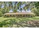 Brick house with metal roof and a long, inviting porch, with mature landscaping at 138 Brant Acres Ln, Bonneau, SC 29431