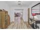 Bright foyer featuring wood-look flooring, a decorative table with a mirror, and an open view to the living area at 138 Brant Acres Ln, Bonneau, SC 29431