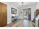 Inviting foyer featuring wood-look flooring, a decorative table with a mirror, and a view to the front porch at 138 Brant Acres Ln, Bonneau, SC 29431