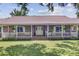 Inviting brick-paved front porch featuring a white picket fence and a welcoming 'Welcome' sign and decorative wreath at 138 Brant Acres Ln, Bonneau, SC 29431
