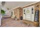 Welcoming front porch with brick flooring, ceiling fan, swing, and decorative touches create a cozy outdoor space at 138 Brant Acres Ln, Bonneau, SC 29431