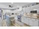 Well-equipped kitchen with white cabinetry, stainless steel appliances, a center island, and modern flooring at 138 Brant Acres Ln, Bonneau, SC 29431