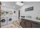 Functional laundry room with modern machines, ample storage, and stylish decor at 138 Brant Acres Ln, Bonneau, SC 29431