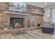 Cozy living room with a brick fireplace, stylish decor, and wood floors at 138 Brant Acres Ln, Bonneau, SC 29431