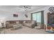Cozy living room featuring a comfortable sectional sofa, ceiling fan, and a large window for natural light at 138 Brant Acres Ln, Bonneau, SC 29431