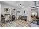 Home office with light-filled window, modern desk, and view of the living area at 138 Brant Acres Ln, Bonneau, SC 29431