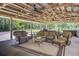 Relaxing covered patio with comfortable seating and ceiling fans, ideal for outdoor living at 138 Brant Acres Ln, Bonneau, SC 29431