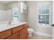 Bright bathroom features a vanity with cabinet storage, a toilet and window with natural light at 1604 Basildon Rd, Mount Pleasant, SC 29466