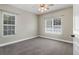 A comfortable carpeted bedroom featuring two windows for natural light at 1604 Basildon Rd, Mount Pleasant, SC 29466