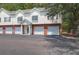 Townhome exteriors feature white siding, brick accents, and individual garages for convenient parking at 1604 Basildon Rd, Mount Pleasant, SC 29466