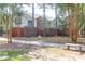 Back view of a complex with brick accents, sidewalks, mature trees, and maintained lawns at 1604 Basildon Rd, Mount Pleasant, SC 29466