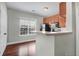 Functional kitchen with wooden floors, wood cabinets, and view to the dining area at 1604 Basildon Rd, Mount Pleasant, SC 29466
