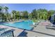 A community pool surrounded by palm trees, plenty of lounge chairs, and well kept landscaping at 1604 Basildon Rd, Mount Pleasant, SC 29466