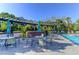 An outdoor grill area, outdoor tables, and lounge chairs next to a community swimming pool at 1604 Basildon Rd, Mount Pleasant, SC 29466