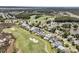 Expansive aerial view of neighborhood homes adjoining a golf course and wooded area at 1636 Rivertowne Country Club Dr, Mount Pleasant, SC 29466