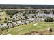 Beautiful aerial panorama of homes bordering a golf course, with a lake and trees at 1636 Rivertowne Country Club Dr, Mount Pleasant, SC 29466